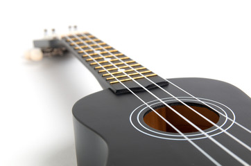 Fototapeta na wymiar black ukulele guitar on white background