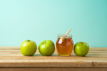 Jewish holiday Rosh Hashana background with honey jar and apples  on wooden table