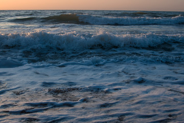 Sunset or dawn on the sea, waves and the sun.