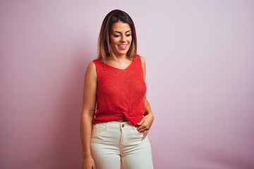 Obraz premium Young beautiful hispanic woman standing wearing orange t-shirt