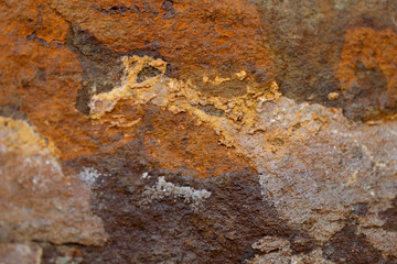 Abstract blurred natural background. Orange with brown rough wall surface. Design concept.