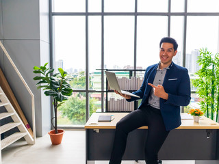 A young Asian businessman with a notebook And smile in the office