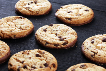 Chocolate cookies on wooden table. Chocolate chip cookies shot on table
