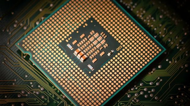 closeup of CPU Chip over electronic circuit board rotating on dolly.