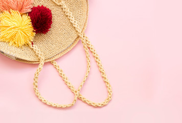 Modern stylish round straw bag on pink background, top view