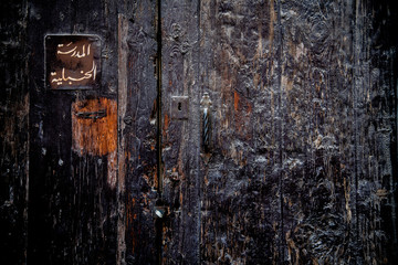 Burnt gate at a mosque in Cairo, with a sign in Arabic script
