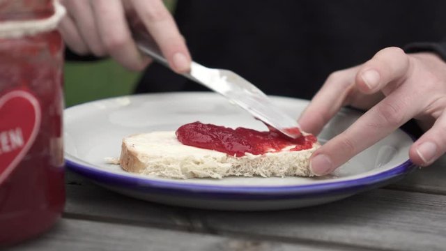 Lockdown: Spreading Delicious Strawberry Jam on a Piece of Bread - Smaland, Sweden
