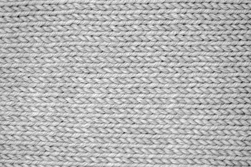 Knitting pattern Knitted seamless background in gray. Knit textures for wallpapers and backgrounds.