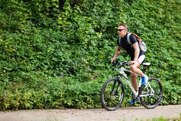 Fototapeta na wymiar A man on a bicycle in the park.
