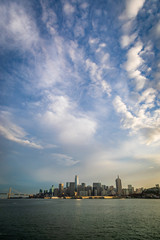 Dramatic clouds and blue sky over the San Francisco skyline including the bay bridge