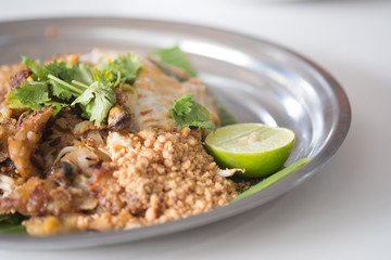 Fried mussel pancakes and Pad Thai in dish