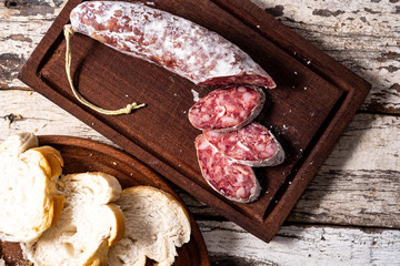 Salami and bread on a wood board