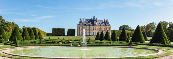 Panoramic view of Parc and chateau de Sceaux with a fountain in foreground - Hauts-de-Seine, France.