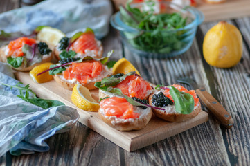 sandwiches with red, black caviar and trout .submitted on wooden planks