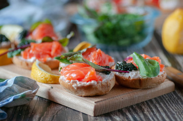 sandwiches with red, black caviar and trout .submitted on wooden planks