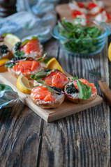sandwiches with red, black caviar and trout .submitted on wooden planks
