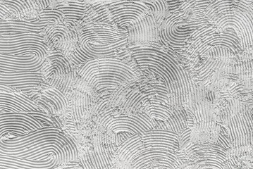 Photo of white stucco in the form of a pattern of relief stripes with irregular semicircles