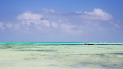 Obraz premium Wooden Fishing Boat in turquoise waters of Indian ocean,Zanzibar,Tanzania