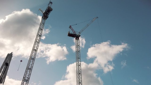 Crane are working on building constraction on blue sky background