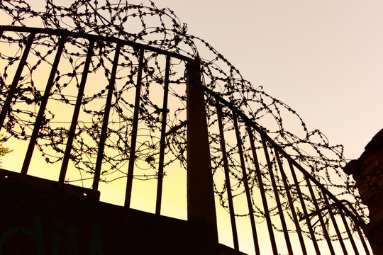 prison state iron gate with barbed wire - isolation quarantine, epidemic, pandemic, virus