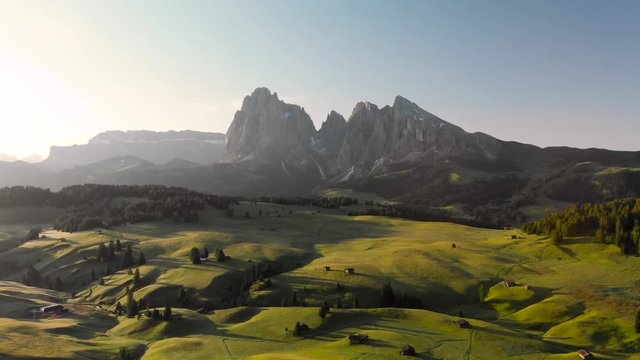 Drone aerial  flying above Alpe di Suisi meadow in the Dolomites mountains Italy Alps. Sunrise at idyllic Seiser Alm valley in South Tyrol, wanderlust hiking travel in Europe