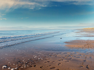 Sunny day on Fanore beach, County Clare Ireland, Blue cloudy sky and water.