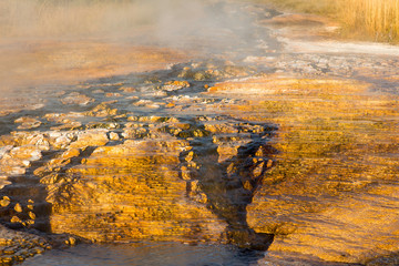 Fototapeta premium hot water flowing between the orange stones