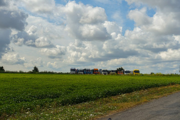 Fototapeta na wymiar road along the field. combine harvesters ready for harvest