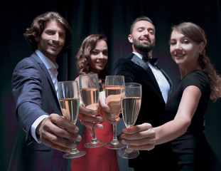 Cheerful people celebrating a sucess with Champagne