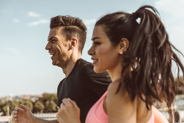 Caucasian man goes out to run and do sport with Latin woman through a park in the city of Madrid