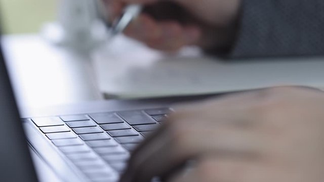 Men hands with  using laptop to work study and writing on paper with a pen. Business, financial, trade stock maket and social network concept.