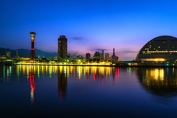 View of night in Kobe, Japan. Cloudless sky with harbor and numerous skyscrapers