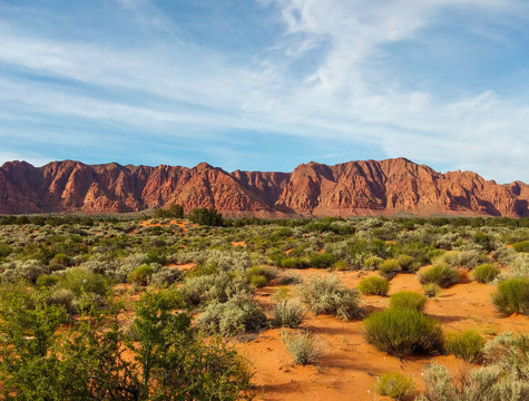 Ivins desert red sandstone mountains under a light cloud cover in Utah
