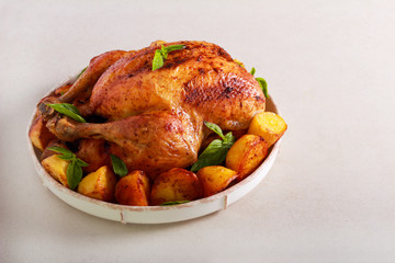 Baked whole chicken with potatoes