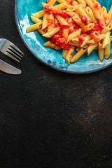 pasta penne and tomato sauce - delicious second course, menu concept. food background. copy space