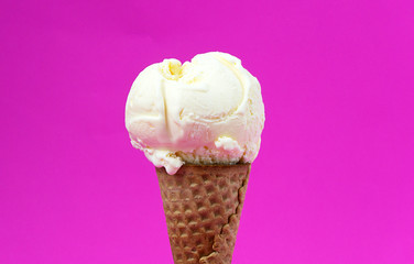Closeup Vanilla ice cream scooped in waffle cone on pink background, Closeup Front view Food concept..