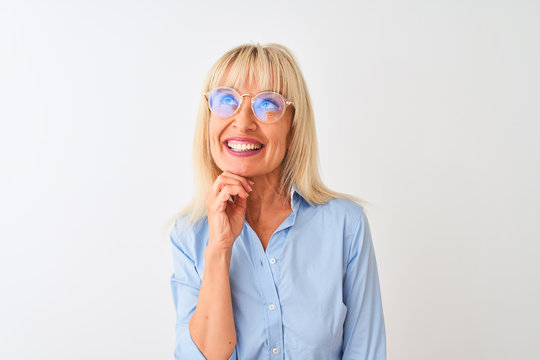Middle age businesswoman wearing glasses and shirt standing over isolated white background serious face thinking about question, very confused idea