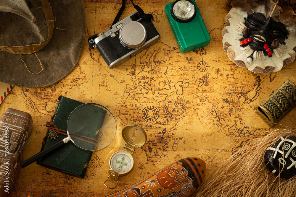 Poster souvenirs from travels around the world. map with a travel notebook and travel equipment in a retro 