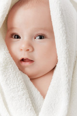 Smiling baby in a towel