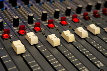 Fototapeta premium Faders on a studio mixing board. 