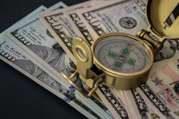 US dollars and compass / concept