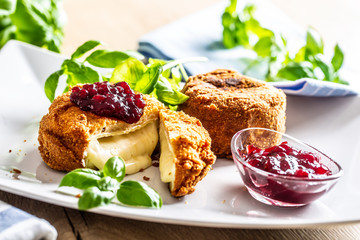 Fried camembert or brie cheese with cranberry jam and basil