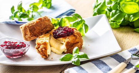 Fried camembert or brie cheese with cranberry jam and basil