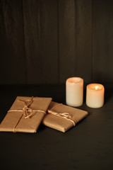 Gift packages in kraft paper and two candles