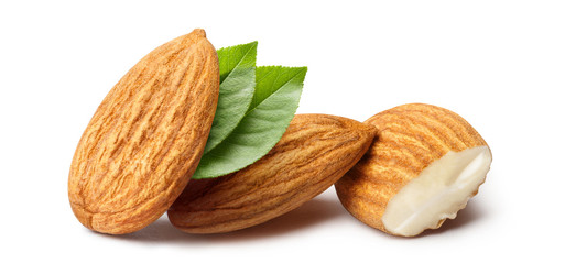 Close-up of almonds with leaves, isolated on white background