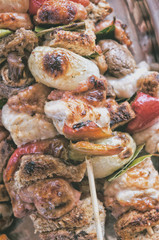 Cooked skewers of meat and vegetables background