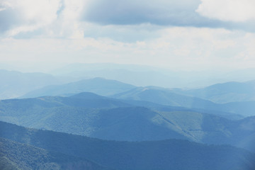 Mountain landscape of blue hills on the background of cloudy sky