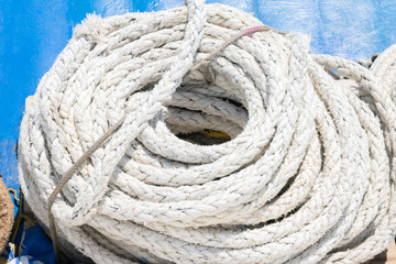 Fototapeta na wymiar Coiled thick rope on the ship in a spiral or sequence of ring