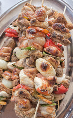Cooked skewers of meat and vegetables background