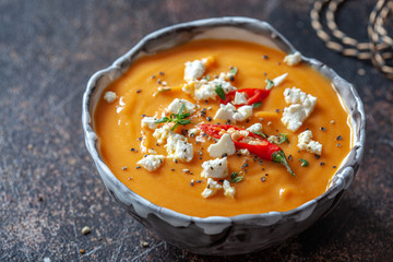 Roasted pumpkin and carrot soup with feta cheese and chili pepper